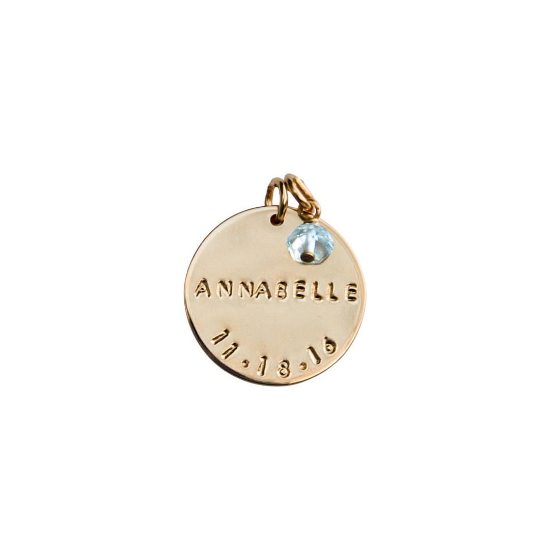 Gold add-on birthdate pendant with hand-stamped name and date, accented by an Aquamarine gemstone charm, from Blooming Lotus Jewelry.