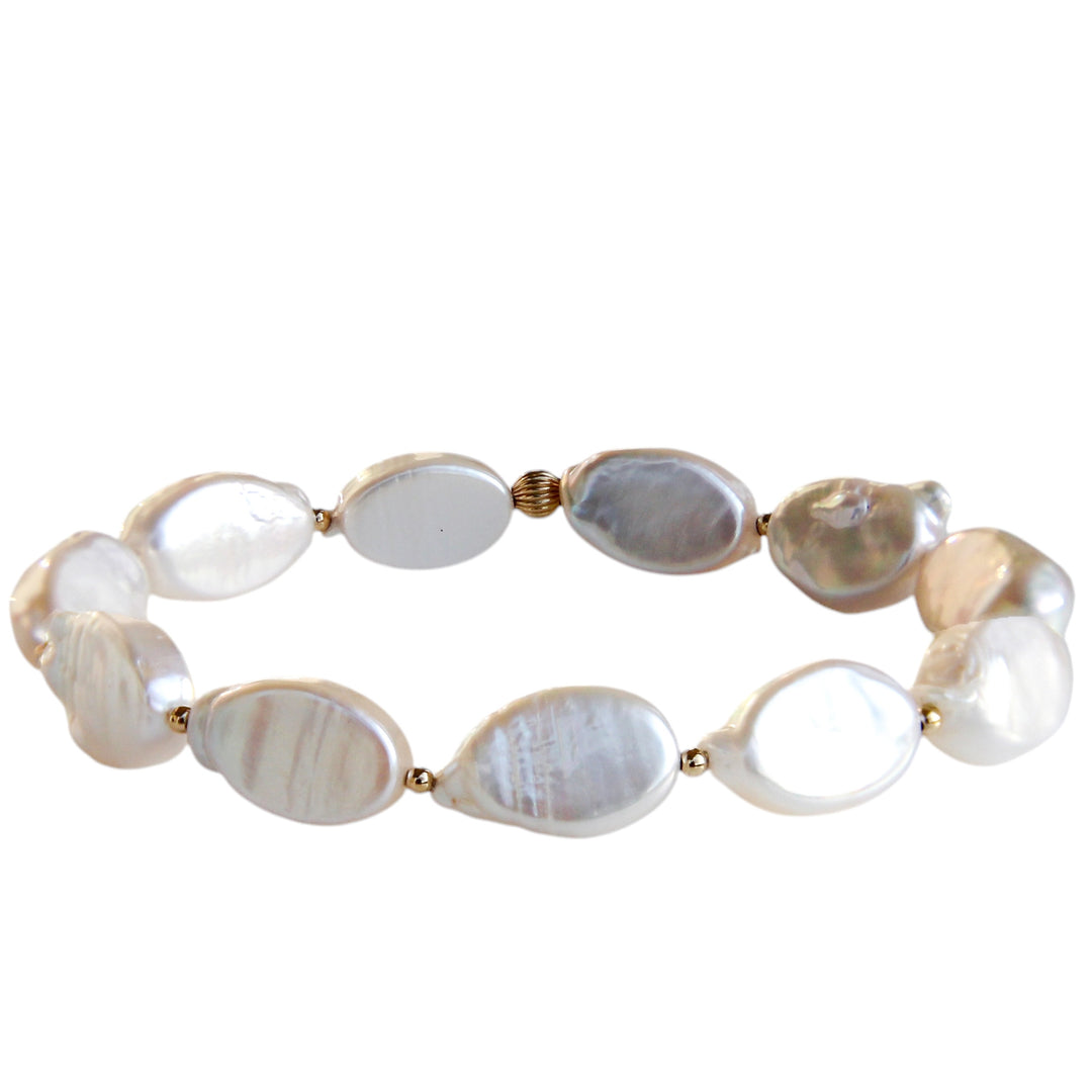 Handcrafted bracelet featuring luminous freshwater pearls with delicate gold bead accents, inspired by the soft shimmer of ocean mist and coastal elegance.