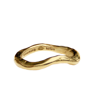 gold wave ring close up with organic texture and logo engraved inside band