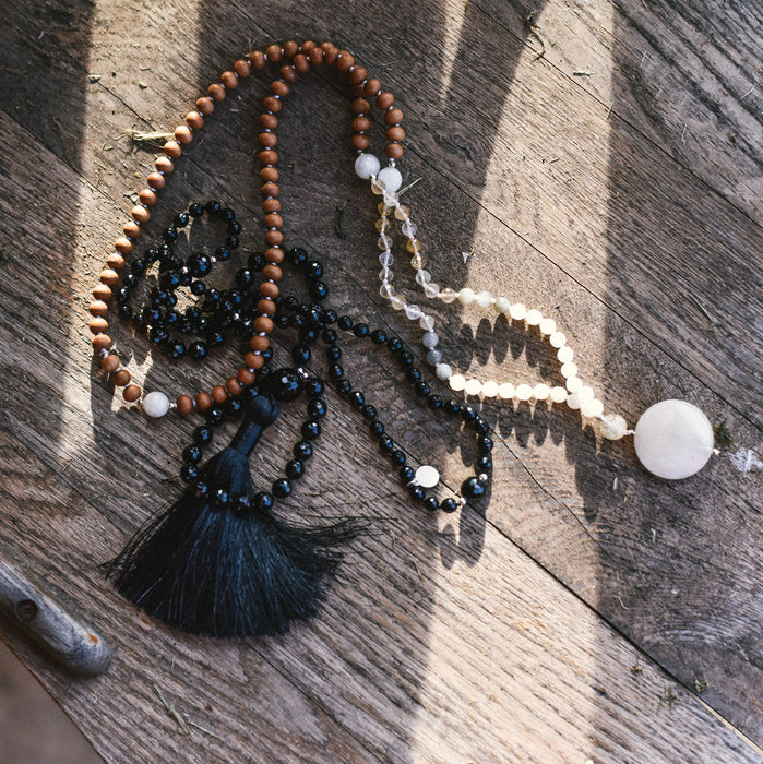 Eclipse Mala and Full Moon Mala Necklace on wood surface - Yoga Jewelry - Blooming Lotus Jewelry