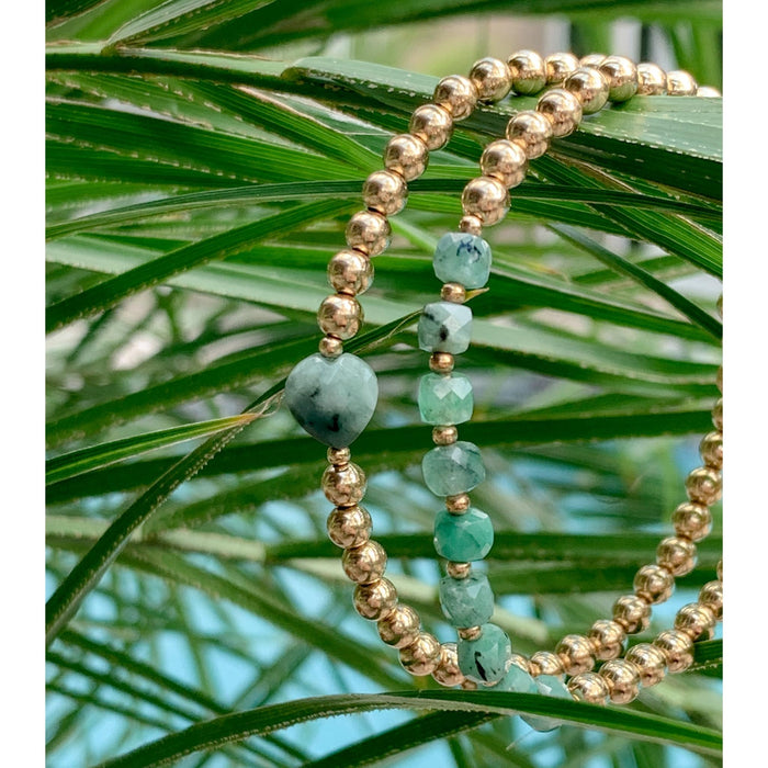 Gold Beaded Bracelets with faceted Emerald cubes and heart gemstones hanging from plant leaves - Blooming Lotus Jewelry