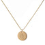 single gold initial disc coin pendant hanging from gold chain hand-stamped with capital B
