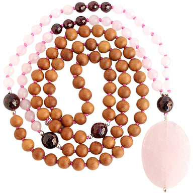 rose quartz garnet sandalwood mala beads necklace coiled up top view with large rose quartz focal stone