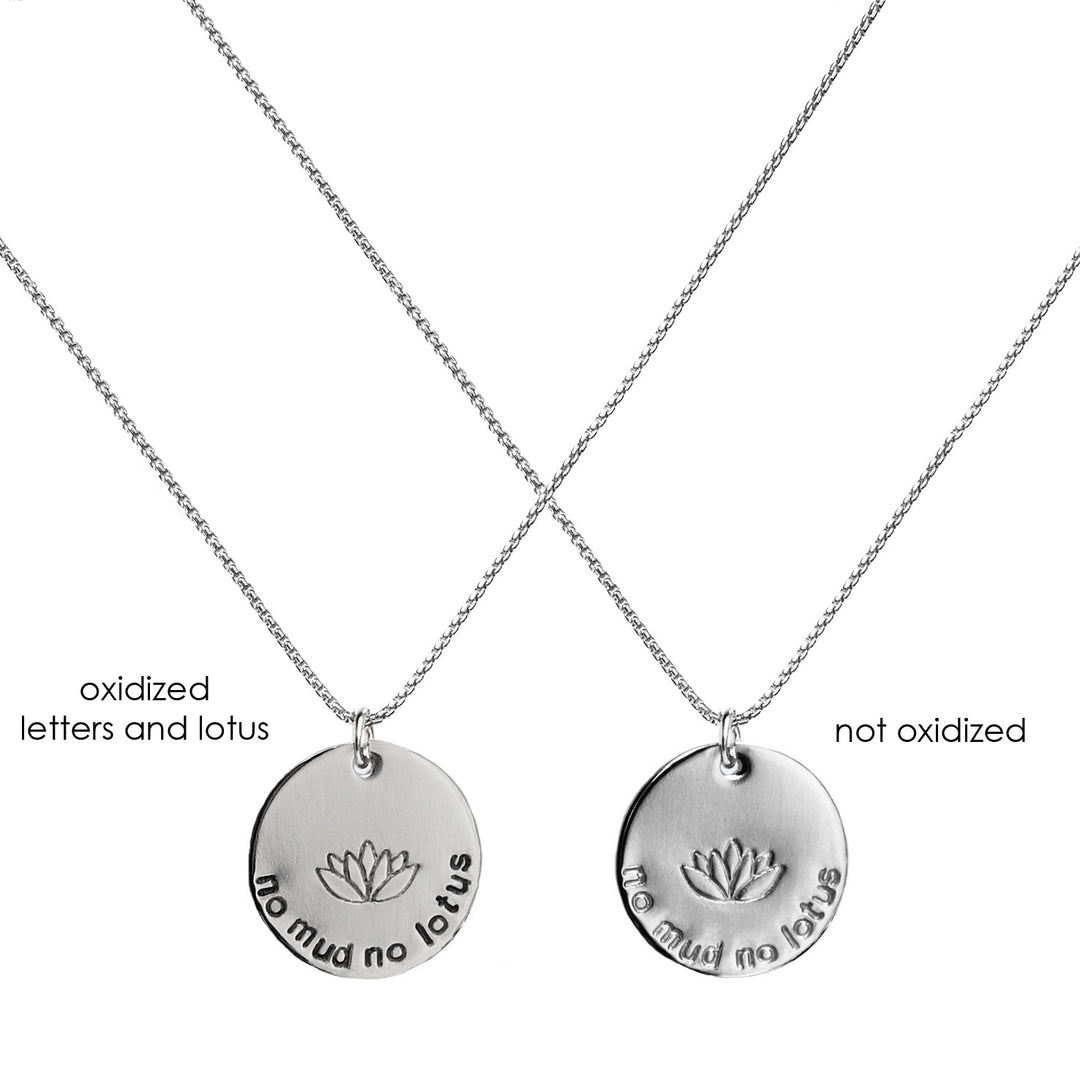 two Mini No Mud No Lotus Necklace in sterling silver, one oxidized and one all silver) with the round pendants hand stamped with a lotus flower and the words “no mud no lotus,” symbolizing new beginnings, strength, and resilience.