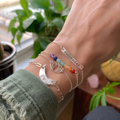 Silver layering bracelets on wrist - mantra bar hand-stamped with surrender chakra gemstones lotus crescent moon on silver chain - Blooming Lotus Jewelry