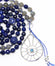 closeup silver evil eye pendant with london blue topaz on lapis lazuli and labradorite mala beads necklace