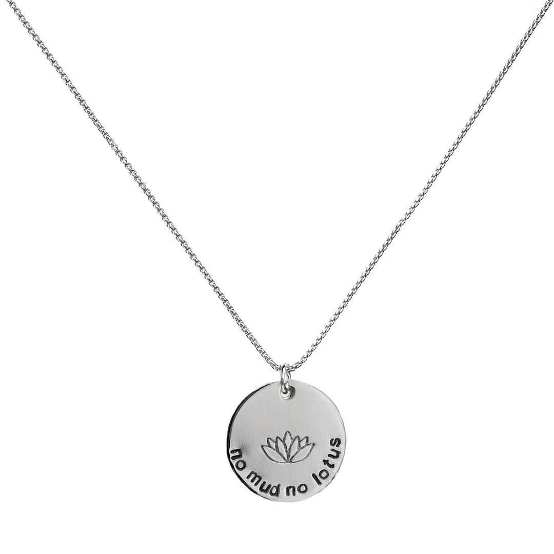 Mini No Mud No Lotus Necklace in sterling silver with a round pendant hand stamped with a lotus flower and the words “no mud no lotus,” symbolizing new beginnings, strength, and resilience.