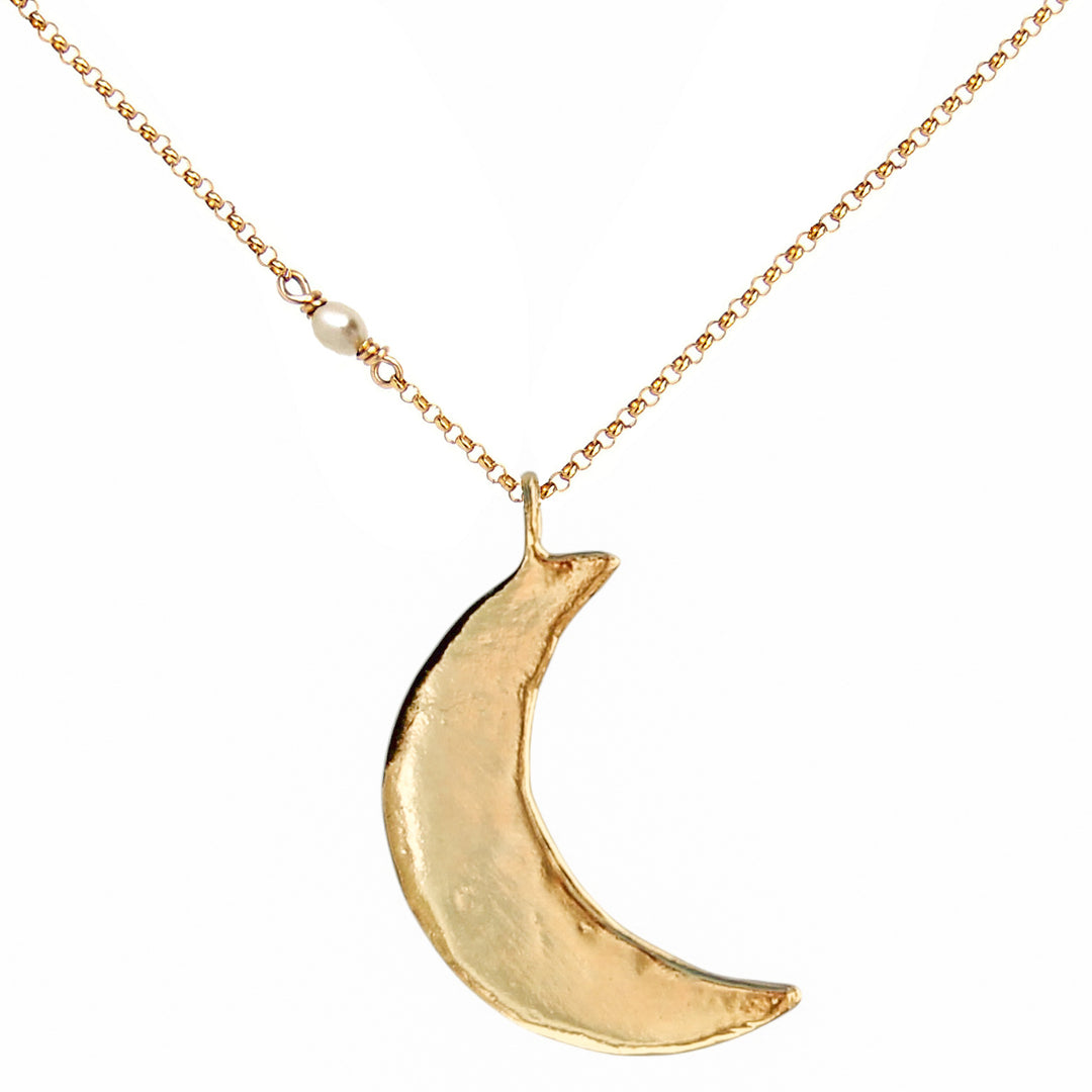 Gold crescent moon necklace with an organic, hand-sculpted texture and dainty pearl detail on the chain. Celestial-inspired jewelry handmade by Blooming Lotus Jewelry.