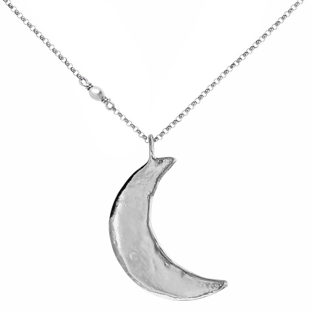 Handcrafted silver crescent moon necklace with an organic, textured finish and delicate pearl detail on the chain – celestial-inspired jewelry by Blooming Lotus Jewelry.