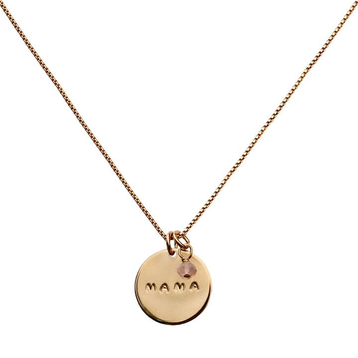 Gold MAMA necklace with round coin pendant hand-stamped with MAMA and rose quartz charm on a gold chain, a meaningful gift for moms by Blooming Lotus Jewelry.