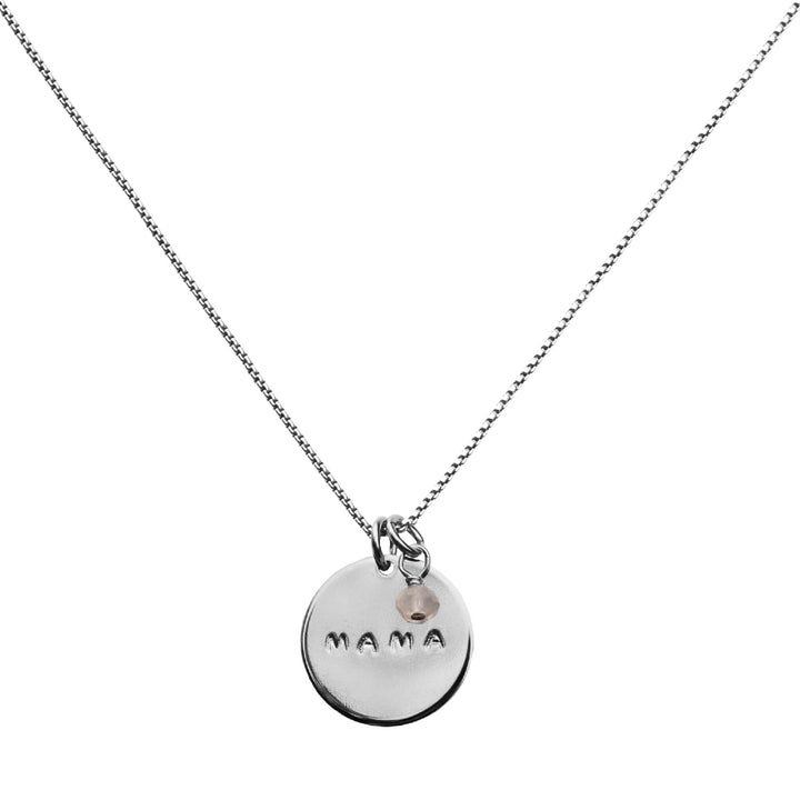 Silver MAMA necklace with round coin pendant hand-stamped with MAMA and rose quartz charm on a silver chain, a meaningful gift for moms by Blooming Lotus Jewelry.