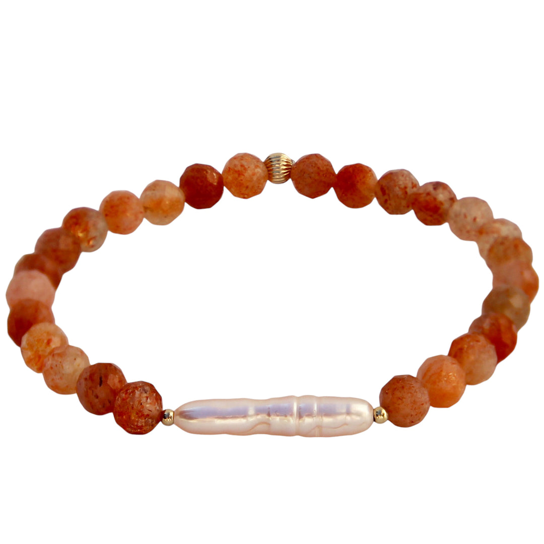 Sunkissed Bracelet featuring faceted round sunstone beads with warm golden-orange tones, accented by a long freshwater Biwa stick pearl centerpiece and small gold bead details, handcrafted by Blooming Lotus Jewelry.