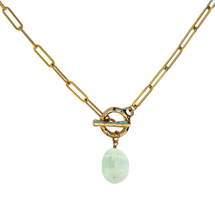 Aquamarine gemstone toggle necklace on a gold paperclip chain, handcrafted by Blooming Lotus Jewelry. A coastal-inspired design symbolizing calm and clarity.