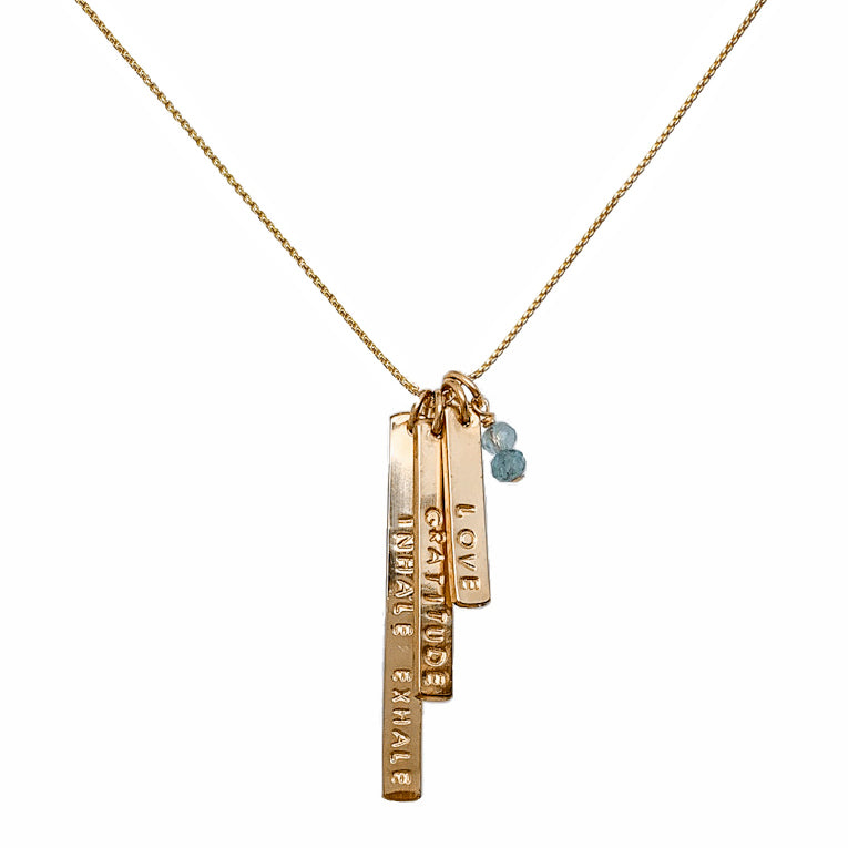 Gold necklace featuring three personalized skinny bar charms stamped with “INHALE EXHALE,” “GRATITUDE,” and “LOVE,” accented with aquamarine gemstone beads — meaningful mantra jewelry by Blooming Lotus Jewelry.