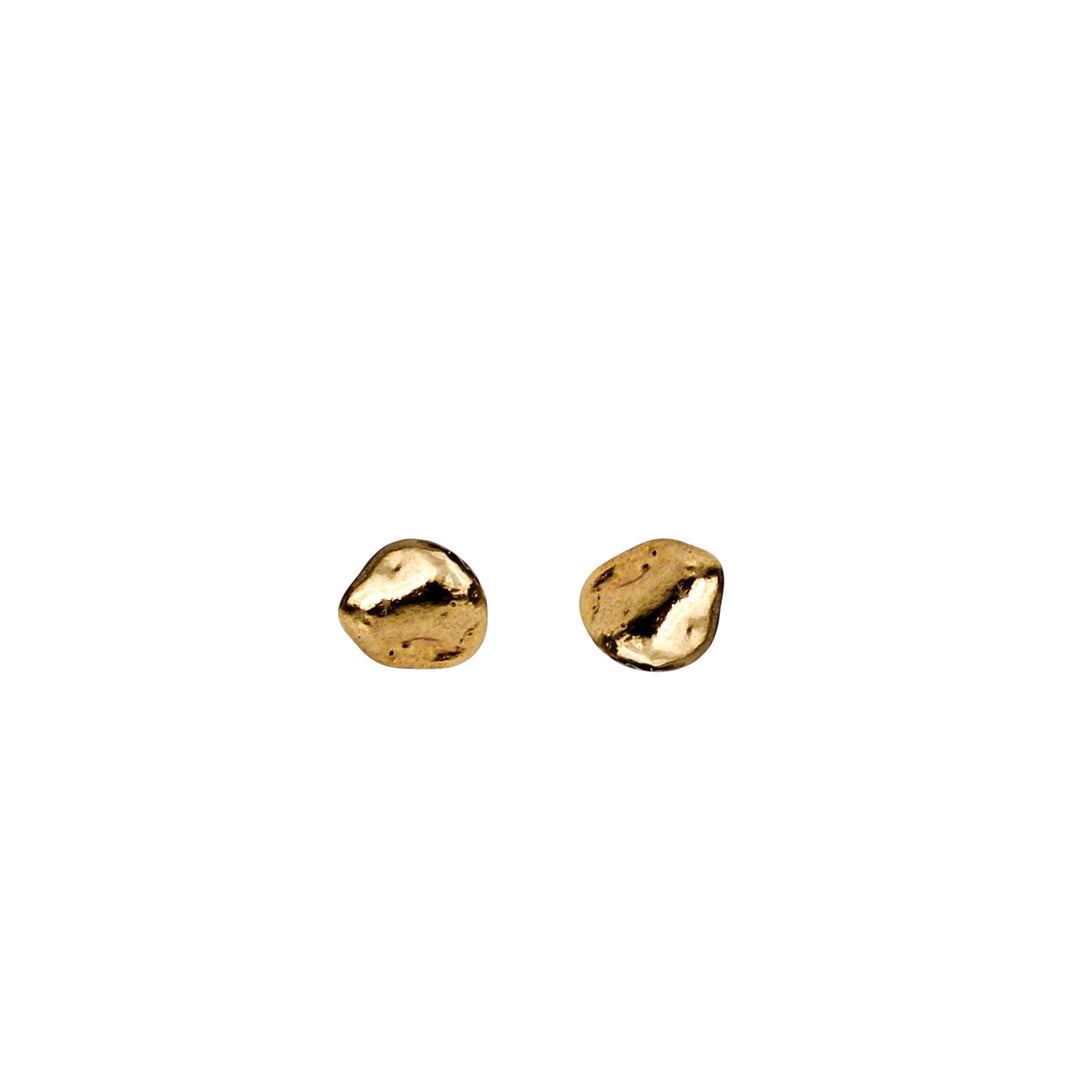 Tiny gold pebble stud earrings with an organic texture shown on a white background, side view.