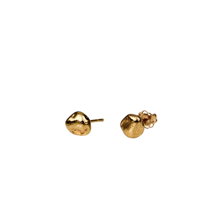 Tiny gold pebble stud earrings with an organic texture shown on a white background, side view.