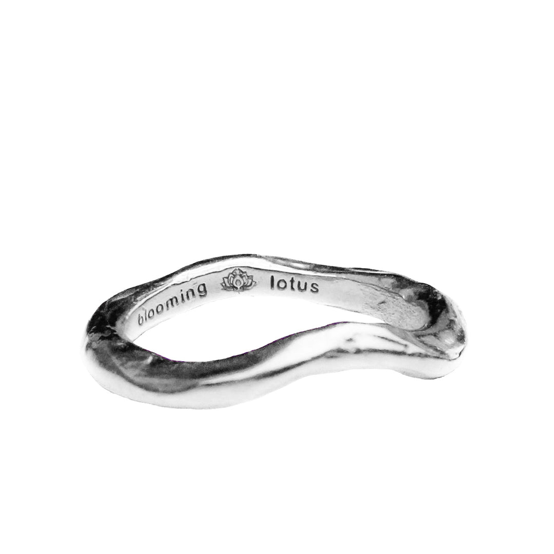 side profile of handcrafted sterling silver wave ring with an organic, coastal-inspire design on white background. 