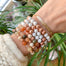 Beaded Gemstone Bracelets Howlite Rutilated Quartz on wrist close up - Blooming Lotus Jewelry