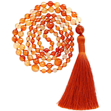 Carnelian gemstone mala beads with orange tassel coiled up top view