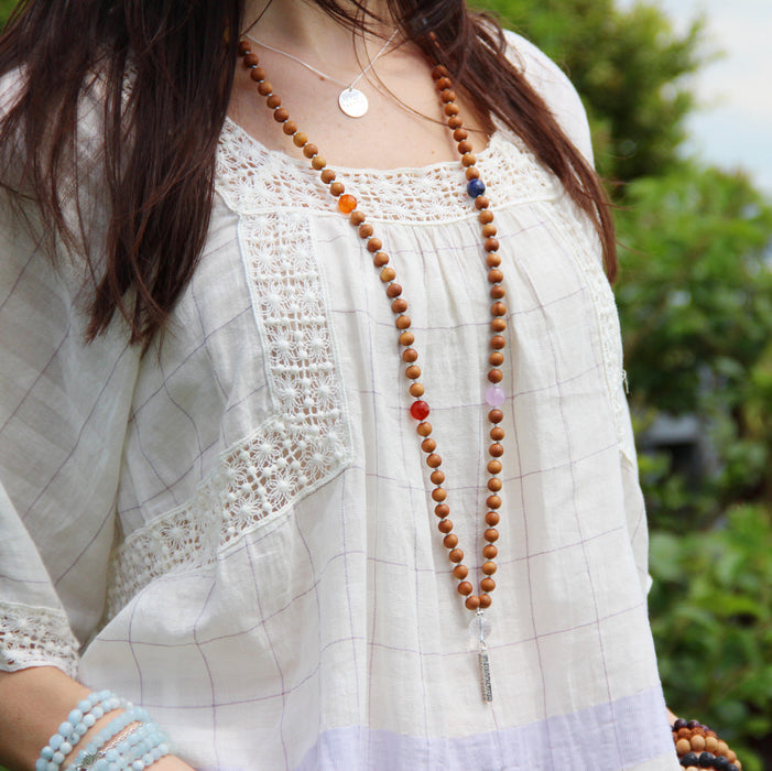 chakra mantra mala beads necklace with silver pendant on model
