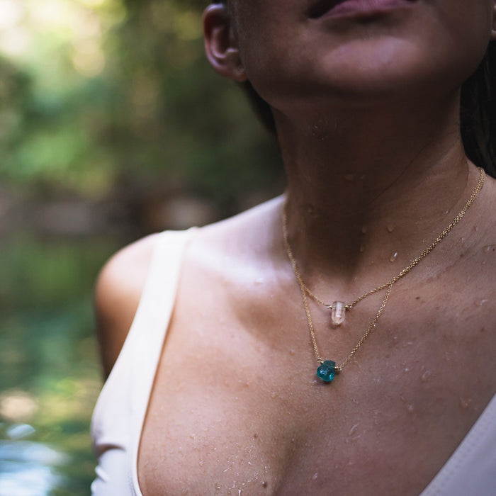 Clear Quartz and Apatite Crystal Necklaces - Clear Quartz - Apatite - gold on model in water - Blooming Lotus Jewelry