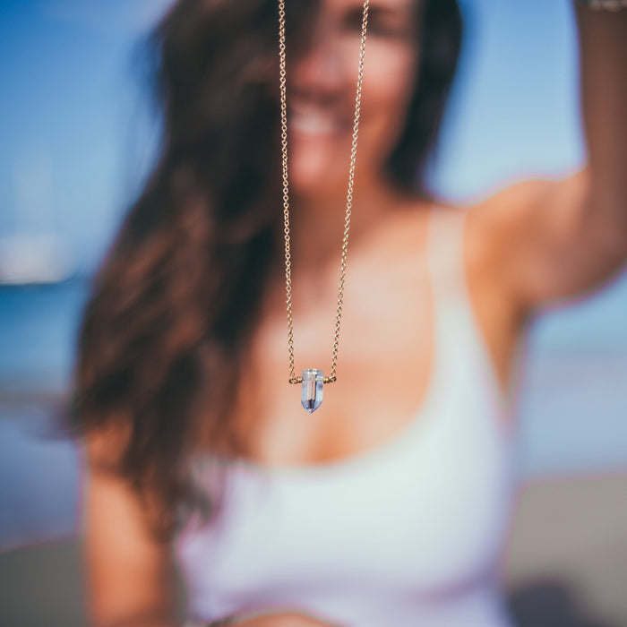 Crystal Necklaces - Clear Quartz necklace on gold chain with model in back - Blooming Lotus Jewelry