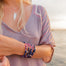 Evil Eye Bracelets with silver charm on model's wrist - Blooming Lotus Jewelry