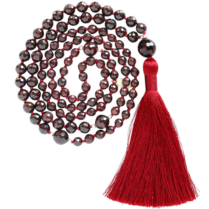 Garnet gemstone mala beads necklace with red tassel coiled up top view