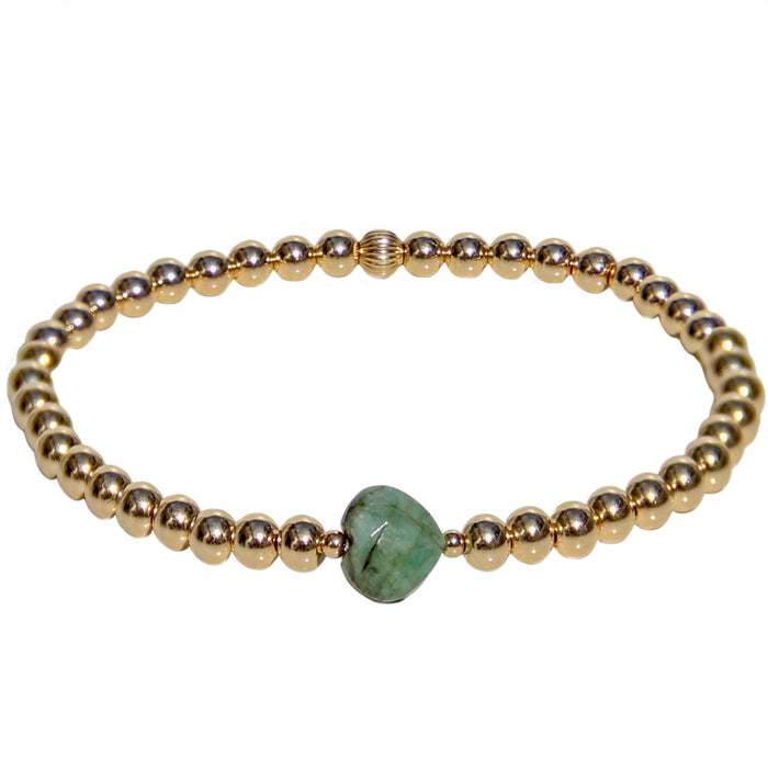gold beaded bracelet with faceted emerald heart gemstone