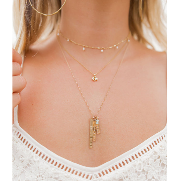 Gold layering necklaces on model - mantra bars moon star choker - Blooming Lotus Jewelry