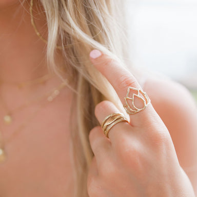 Gold stacking rings lotus love mantra on model closeup - Blooming Lotus Jewelry