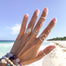 Stacking Rings - Sideways Heart - Lotus - silver - on models hand at beach - Blooming Lotus Jewelry