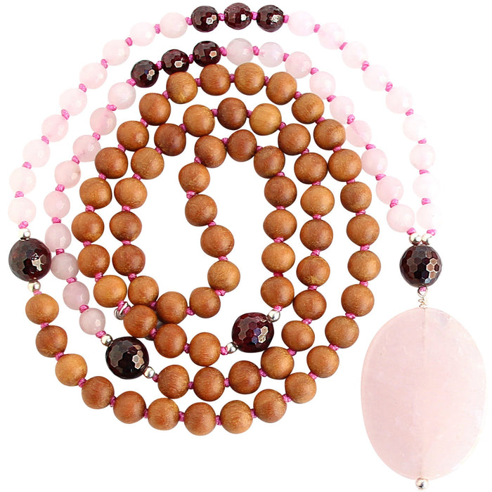 rose quartz garnet sandalwood mala beads necklace coiled up top view with large rose quartz focal stone