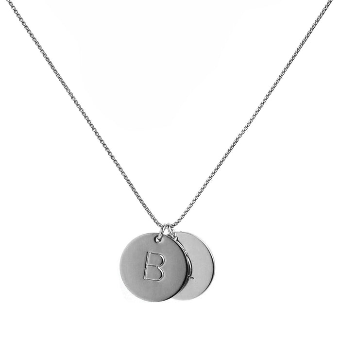 two single silver initial disc coin pendants hanging from silver chain hand-stamped with capital B