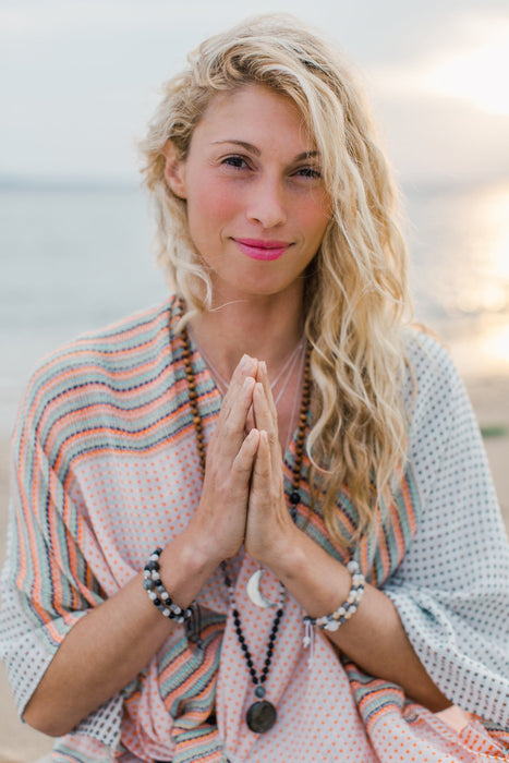 New Moon Mala Necklace on model in prayer position - meditation yoga jewelry - Blooming Lotus Jewelry