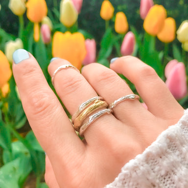 Olive Branch Twig Stacking Rings gold and silver close up on hand - Blooming Lotus Jewelry