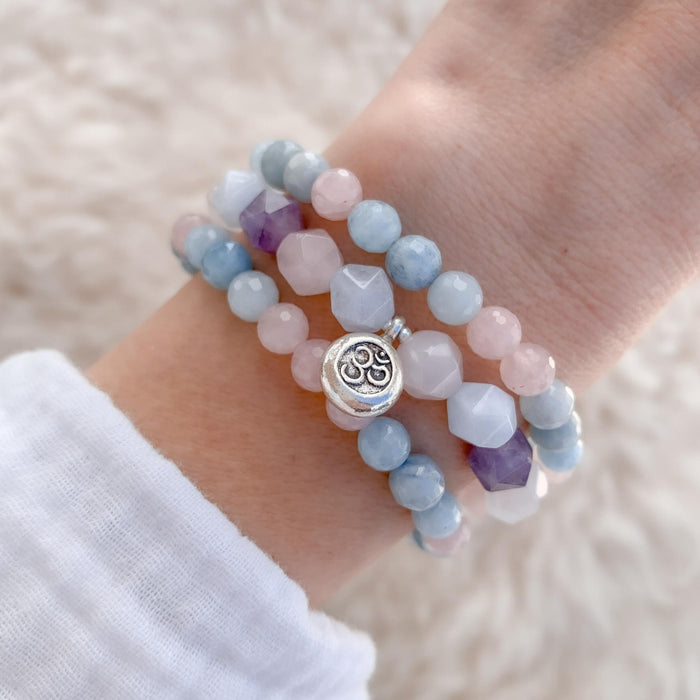 Om Gemstone Yoga bracelets on wrist - rose quartz aquamarine amethyst - Blooming Lotus Jewelry