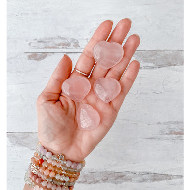 Rose Quartz Crystal Heart in hand - Blooming Lotus Jewelry