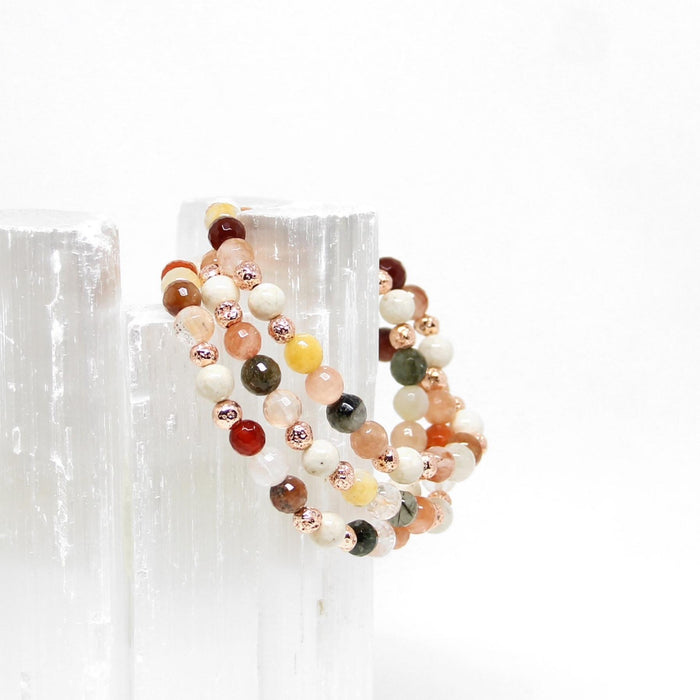 Rutilated Quartz gemstone bracelets hanging on selenite - Blooming Lotus Jewelry
