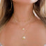 shell necklaces layered on models neck - Blooming Lotus Jewelry