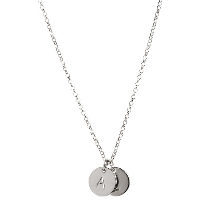 two tiny silver initial disc coin pendants hanging from chain - personalized hand-stamped 