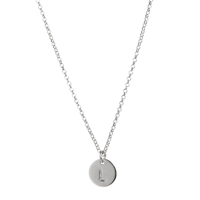 single tiny silver initial disc coin pendant hanging from chain - personalized hand-stamped