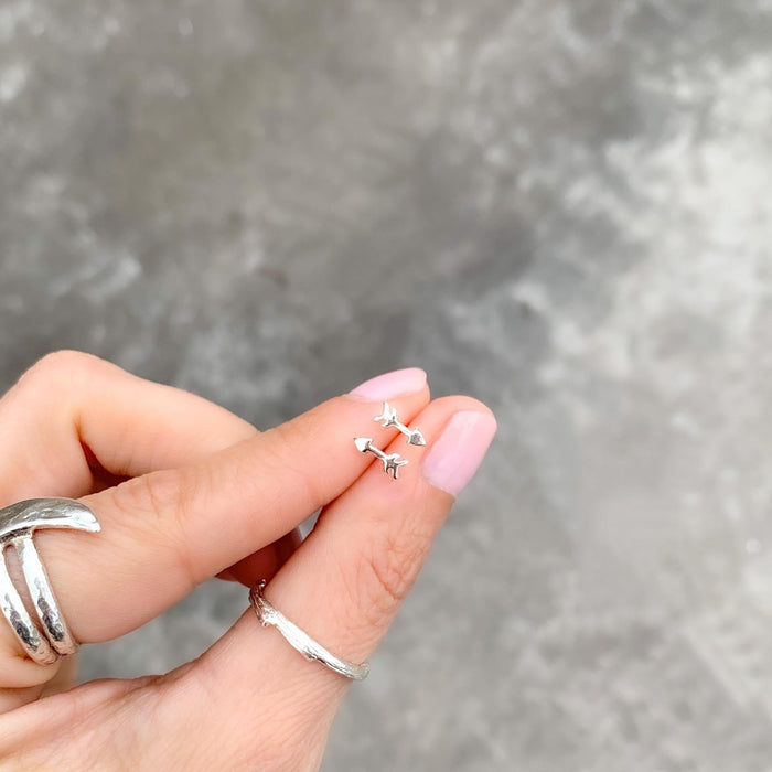 Tiny Arrow Stud Earrings in hand - Blooming Lotus Jewelry