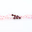 close up hand-knotted mala beads rose quartz and garnet