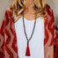 garnet mala beads necklace with tassel on model with red sweater