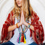 several gemstone mala beads necklace with tassels on yoga model holding hands in prayer namaste